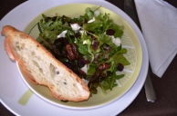 a simple salad with goat cheese, walnuts and cranberries